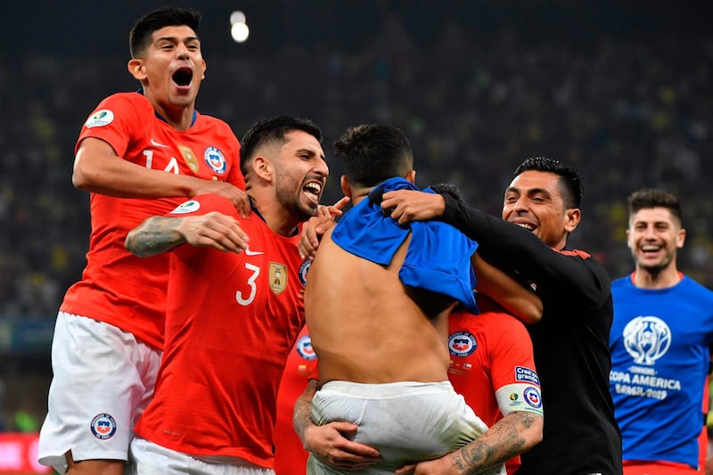 Chile players celebrate with Alexis Sanchez after the shootout win over Colombia. AFP