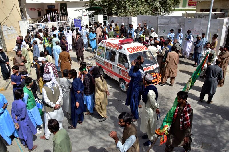 People gather at a hospital in Quetta, Pakistan, as injured victims of the explosion are brought in. AP