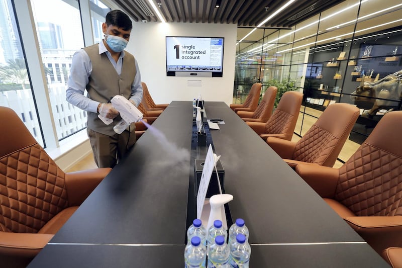 Dubai, United Arab Emirates - Reporter: N/A. Standalone. Covid-19/Coronavirus. Rohit an employee at Century Financial sterilises a conference room. Employees are required to wear masks, gloves and overshoes. Thursday, August 27th, 2020. Dubai. Chris Whiteoak / The National