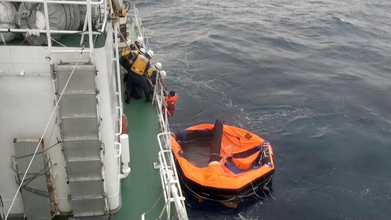 A Filipino crew member of Gulf Livestock 1 is rescued by Japan Coast Guard crew onboard the vessel Kaimon. Reuters