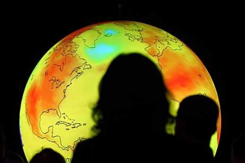 Participants watch an animated projection, showing the effects of climate change, during the United Nations climate change conference in Copenhagen last December.