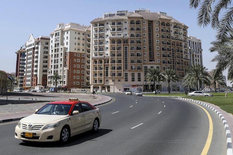 Above, apartment buildings in International City developed by Nakheel. Antonie Robertson / The National