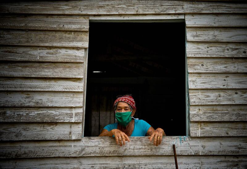 An elderly lady wears a face mask to prevent the spread of the novel coronavirus in Zaragoza, Mayabeque province, Cuba.   AFP