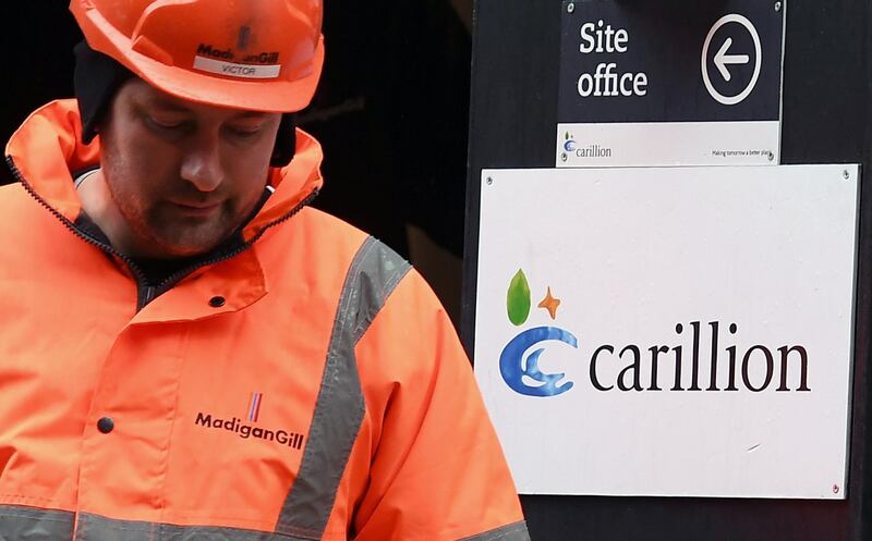 epa06440399 A Carillion employee exits a site office in London, Britain, 15 January 2018. Thousands of jobs in the UK and abroad maybe lost following the news that Construction company Carillion is to go into liquidation. Talks between lenders and the UK government has failed to reach a deal.  EPA/ANDY RAIN