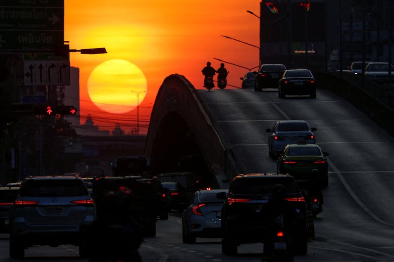 Traffic silhouetted against the sunrise in Bangkok, Thailand. Reuters