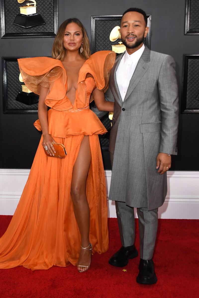 Chrissy Teigen wears Yanina as she and John Legend arrive for the 62nd Annual Grammy Awards on January 26, 2020. AFP