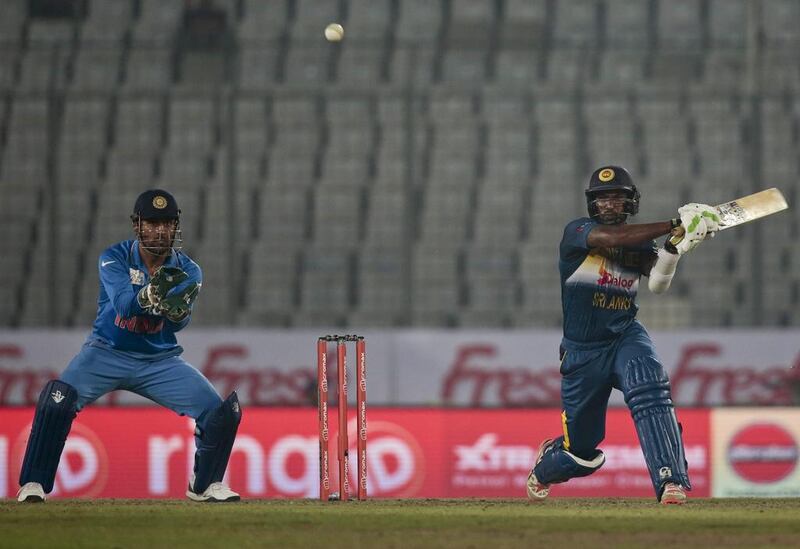 Sri Lanka’s Chamara Kapugedera, right, plays a shot, as India’s wicketkeeper captain Mahendra Dhoni follows the ball during their Asia Cup Twenty20 international cricket match in Dhaka, Bangladesh, Tuesday, March 1, 2016. (AP Photo/A.M. Ahad)