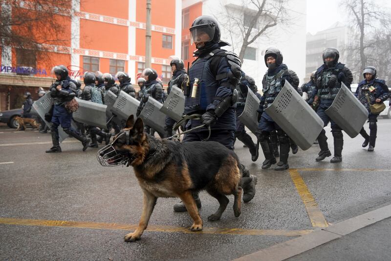 Riot police walk to block demonstrators gathering during a protest in Almaty, Kazakhstan, on January 5. Demonstrators denouncing the doubling of prices for liquefied gas have clashed with police and held protests in about a dozen cities in the country. AP