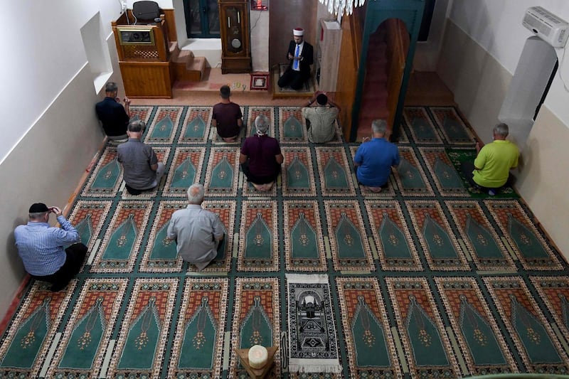 Muslim men take part in Eid Al-Adha prayer in a mosque in the village of Dinos near capital Podgorica on July 31, 2020. Eid al-Adha, the Festival of Sacrifice, is celebrated throughout the Muslim world as a commemoration of Abraham's willingness to sacrifice his son for God, and cows, camels, goats and sheep are traditionally slaughtered on the holiest day. / AFP / Savo PRELEVIC
