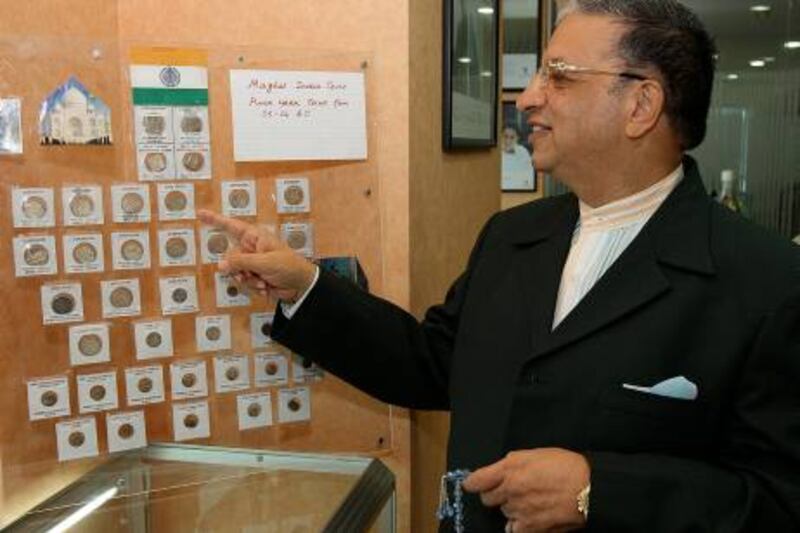 DUBAI, UNITED ARAB EMIRATES Ð Sep 28: Ram Kumar Tolani, Managing Director of Goodwill Insurance Brokers LLC showing some of his collection of coins from around the world in his office at the Atrium Centre in Dubai. (Pawan Singh / The National) For News. Story by Surya
