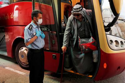 A Palestinian man alights from a bus upon his return from abroad, at the Allenby Bridge crossing in Jericho, in 2020. Reuters