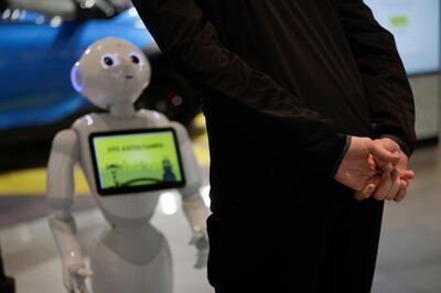 A guests asks robot Robby Pepper for information at the front desk of hotel in Peschiera del Garda, northern Italy, Monday, March 12, 2018. Robby Pepper, billed as Italyâ€™s first robot concierge, has been programed to answer simple guest questions in Italian, English and German, the humanoid, speaking robot will be deployed all season at a hotel on the popular Garda Lake to help relieve the desk staff of simple, repetitive questions. (AP Photo/Luca Bruno)