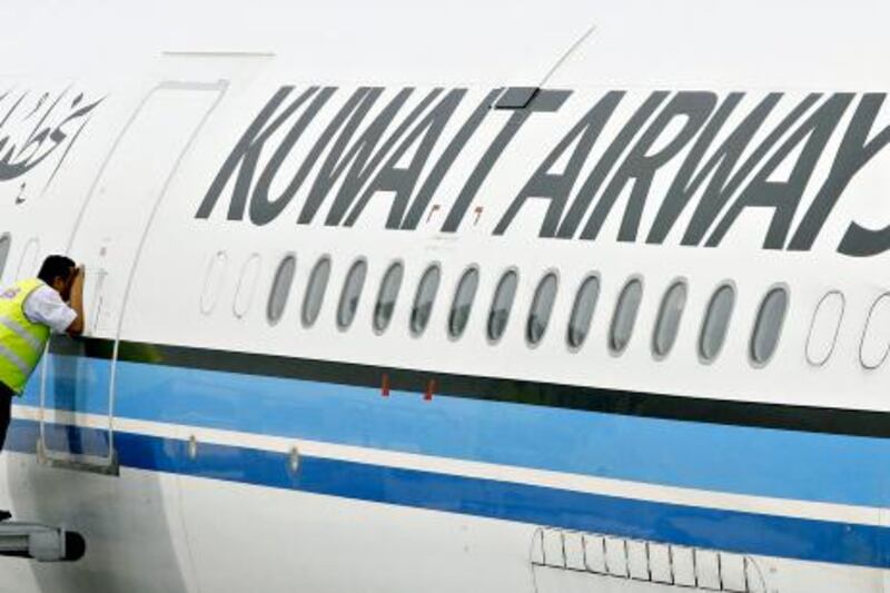 (FILES) A picture taken on November 1, 2006 shows a ground crewmember taking a peek inside the cabin of a Kuwait Airways Airbus A340 at the Kuala Lumpur International Airport in Sepang. State-owned Kuwait Airways incurred a 55 million dinar (189 million dollar) loss last year due to stiff competition and high fuel prices, its chairman said in comments published on May 20, 2010. AFP PHOTO/TENGKU BAHAR *** Local Caption ***  567014-01-08.jpg