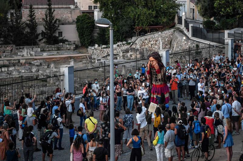 Members of the public gather around Little Amal near the ancient Keramikos cemetery in Greek capital Athens. AFP