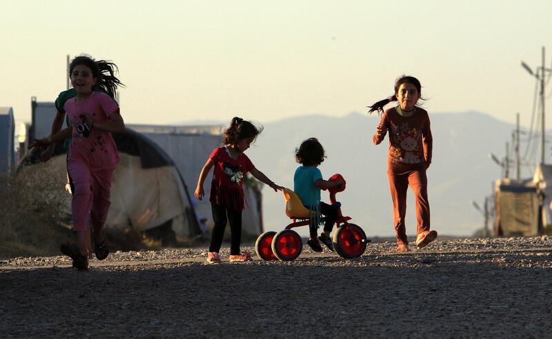 Displaced Iraqi children from the minority Yazidi sect, who fled the Iraqi town of Sinjar, play at the Khanki camp on the outskirts of Dohuk province. Reuters, file