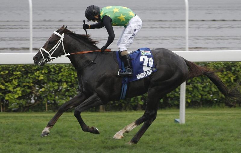 South African horse Variety Club, ridden by Anton Marcus, crosses the finish line to win the Champions Mile at the Sha Tin Racecourse in Hong Kong on May 4, 2014. Vincent Yu / AP Photo