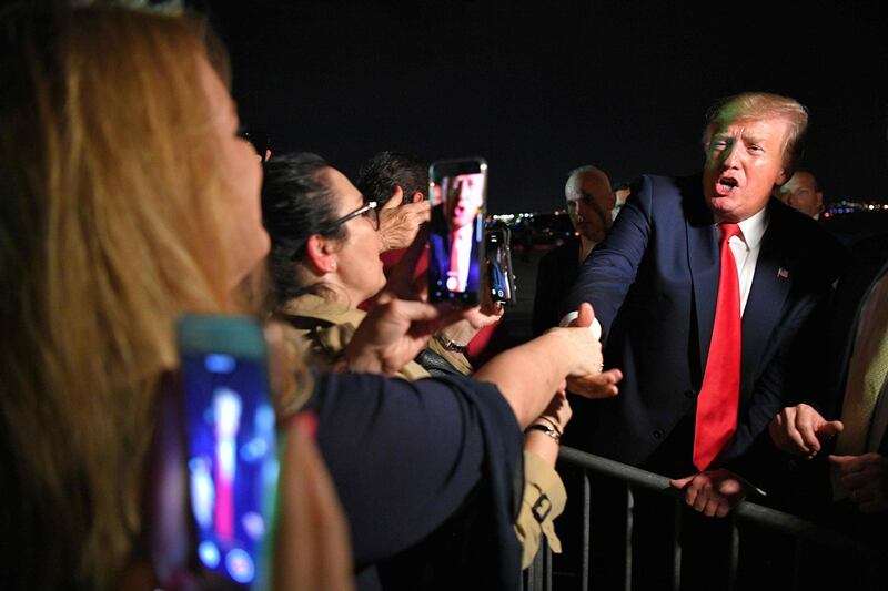 US President Donald Trump meets fans after stepping off Air Force One upon arrival at Miami International Airport in Miami, Florida.  AFP