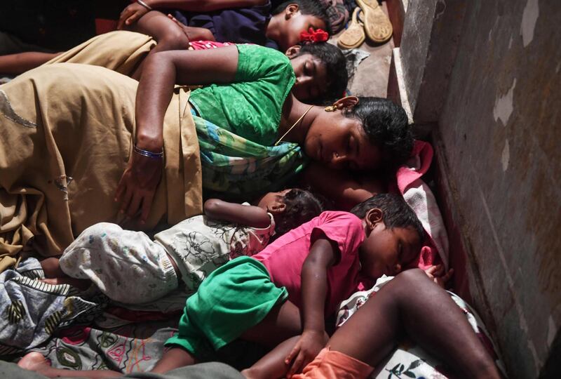 People rest in a cyclone relief shelter in Puri in the eastern Indian state of Odisha as cyclone Fani approaches the Indian coastline. AFP