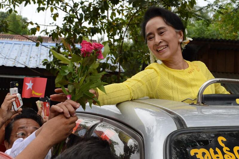 Myanmar opposition leader Aung San Suu Kyi receives roses from a supporter during a campaign rally for the National League for Democracy (NLD) in Kawhmu. Romeo Gacad / AFP 

