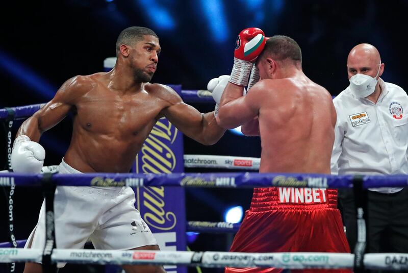 Anthony Joshua, left, throws a punch at challenger Pulev.