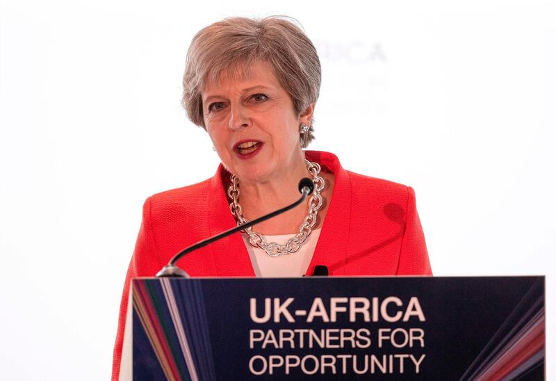 British Prime Minister Theresa May addresses business leaders at the offices of the First National Bank in Cape Town, on August 28, 2018, as part as part of a three-day, three-nation visit to Africa focused on post-Brexit trade ties. (Photo by NIC BOTHMA / POOL / AFP)