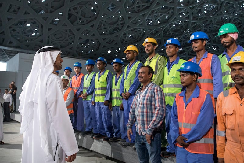 SAADIYAT ISLAND, ABU DHABI, UNITED ARAB EMIRATES - September 11, 2017: HH Sheikh Mohamed bin Zayed Al Nahyan, Crown Prince of Abu Dhabi and Deputy Supreme Commander of the UAE Armed Forces (L), speaks with construction workers while touring the newly constructed Louvre Abu Dhabi. 
( Ryan Carter / Crown Prince Court - Abu Dhabi )
---