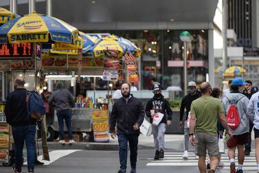A man without a mask crosses a street in Manhattan, New York. AFP