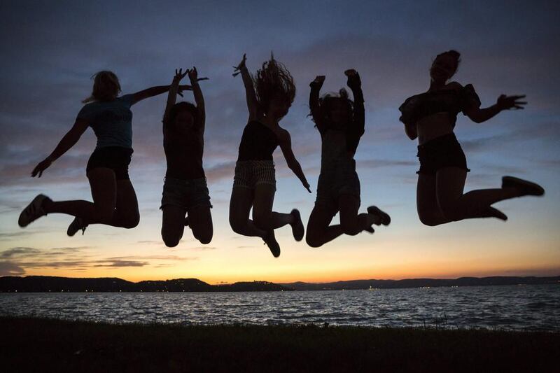 Revelers jump in the air on the shore of Lake Balaton during the opening of the Balaton Sound music festival in Zamardi, 110 kilometres southwest of Budapest, Hungary. Balazs Mohai / EPA