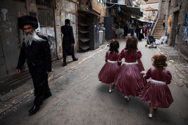Ultra-Orthodox Jewish girls in Jerusalem are dressed to celebrate the holiday of Purim, which commemorates the Jews' salvation from genocide in ancient Persia. AP