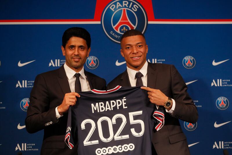 Kylian Mbappe and PSG president Nasser Al-Khelaifi during a press conference to announce the striker's new contract. AP