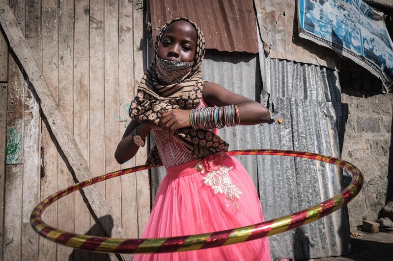 An orphan plays with her new hula hoop during an Eid Al Fitr food and toy distribution for total about 500 orphans in 11 orphanages in Nairobi, Kenya.   AFP