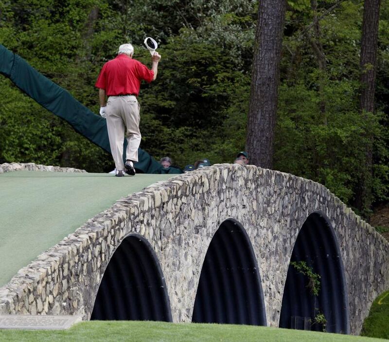 This April 9, 2004, file photo shows Arnold Palmer walking across the Hogan Bridge on the 12th fairway for the final time in Masters competition during the second round at the Augusta National Golf Club in Augusta, Georgia. Amy Sancetta / AP Photo
