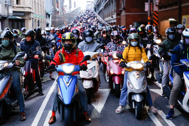 Motorcyclists wait at red traffic lights in morning rush hour in Taipei. Reuters