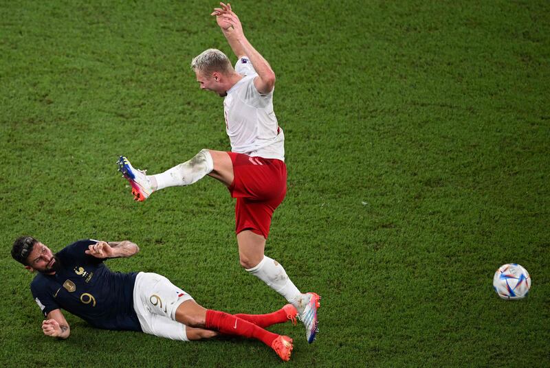 France's Olivier Giroud slides in on Denmark's Victor Nelsson. AFP