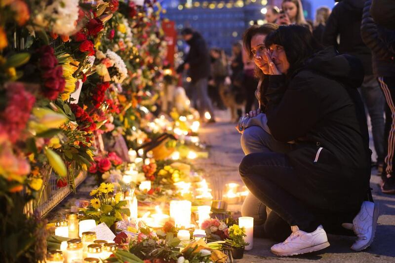 Two women mourn at the site of the terror attack in central Stockholm. Markus Schreiber / AP
