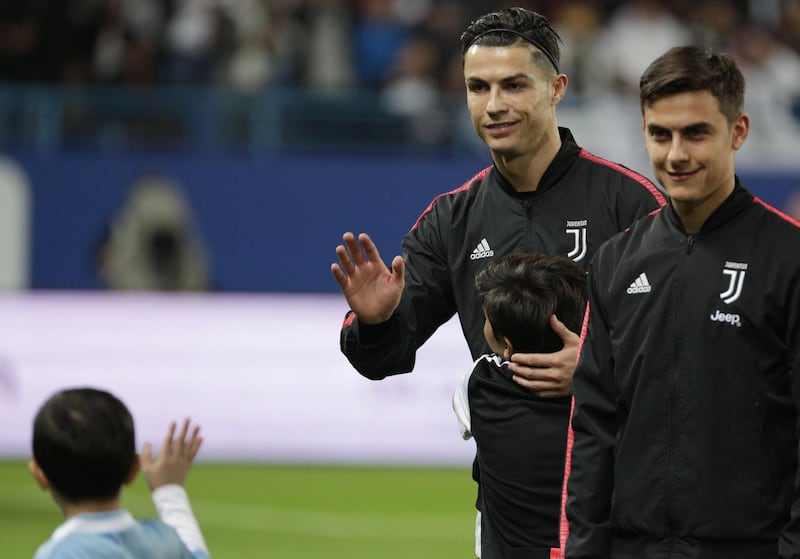 Juventus' Cristiano Ronaldo waves to a young fan following the Italian Super Cup defeat to Lazio at the King Saud University Stadium in Riyadh in Saudi Arabia on Sunday. EPA