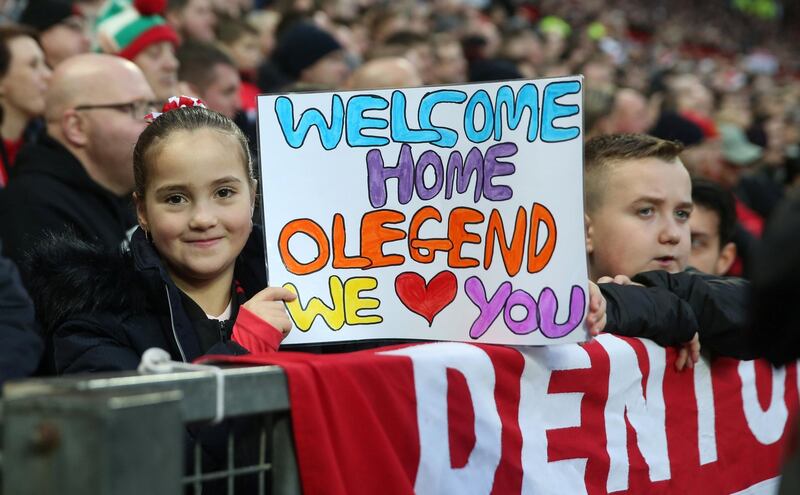 A fan with a banner in reference to Solskjaer. Reuters