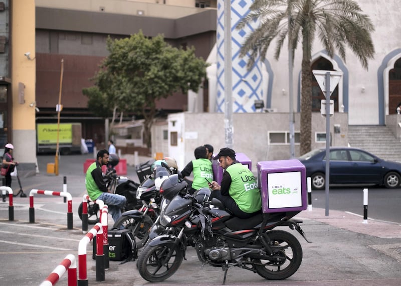 DUBAI, UNITED ARAB EMIRATES. 9 AUGUST 2019. Uber motorcyclists outside Omar Ali Bin Haider Mosque. Established in 1952 by the late Omar Ali bin Haider, the mosque is one of the city's oldest buildings. Mr bin Haider's son Mohammed Omar, the chairman of Mohammed Omar Bin Haider Group, refurbished the house of worship in 1985, preserving its unique shape and symbolic design. The mosque is adjacent to Al Ghurair Centre on a byway of Al Rigga Street. (Photo: Reem Mohammed/The National)Reporter:Section: STANDALONE