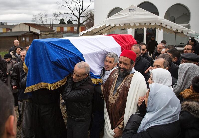A coffin containing the body of murdered Muslim police officer Ahmed Merabet is carried during a funeral on January 13 in Bobigny, France. The officer was awarded a posthumous Legion d'Honneur, in recognition of his bravery. Dan Kitwood / Getty Images