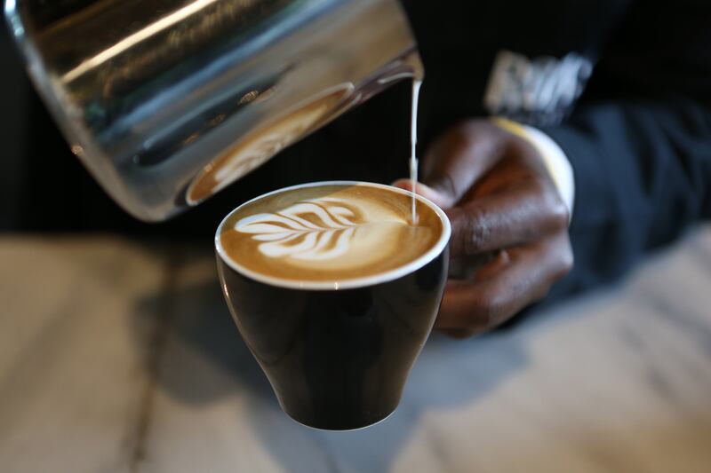 ABU DHABI , UNITED ARAB EMIRATES – Aug 24 , 2015 : Barista Fred Owino making coffee at the Leopolds of London cafe at the Nation Towers in Abu Dhabi. ( Pawan Singh / The National ) For Weekend. Story by Melinda Healy *** Local Caption ***  PS2408- LOL CAFE21.jpg
