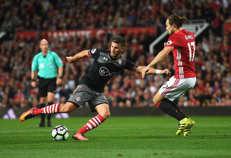 Shane Long of Southampton takes on Daley Blind of Manchester United last week. Michael Regan / Getty Images