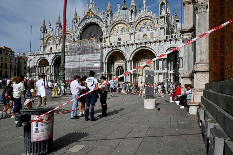 A cordoned area at the bottom of the bell tower at St Mark's in Venice after the wind knocked pieces from the roof on Thursday. AFP