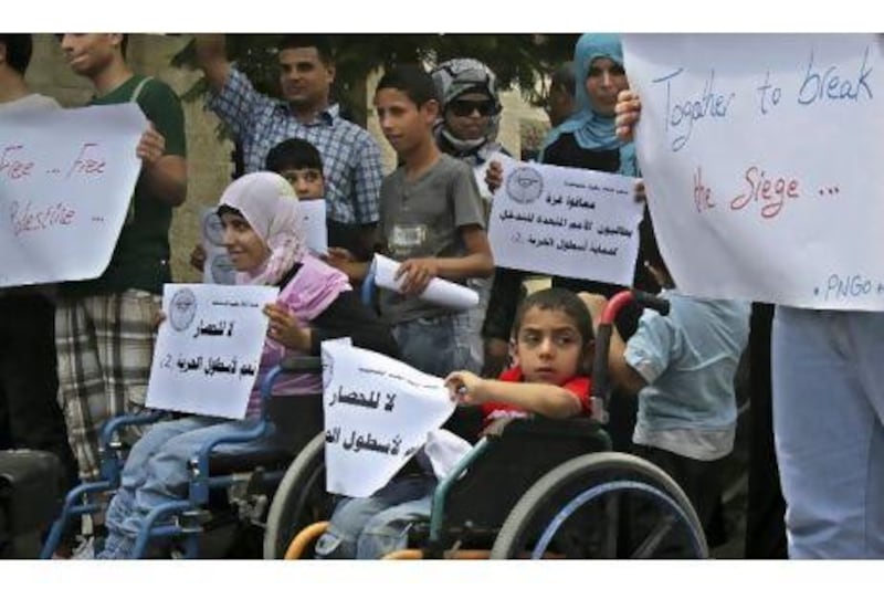 Disabled Palestinian children participate in a protest calling for international protection for the planned international flotilla to blockaded Gaza, in front of the Office of the United Nations Special Coordinator for the Middle East Peace Process in Gaza City. Adel Hana / AP Photo