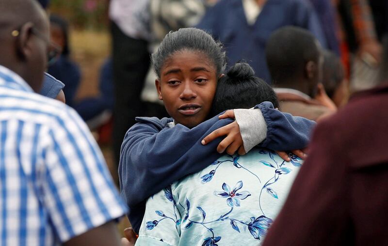 A student embraces her parent following a fire which burnt down one dormitory of Moi Girls school in Nairobi, Kenya September 2, 2017. REUTERS/Baz Ratner