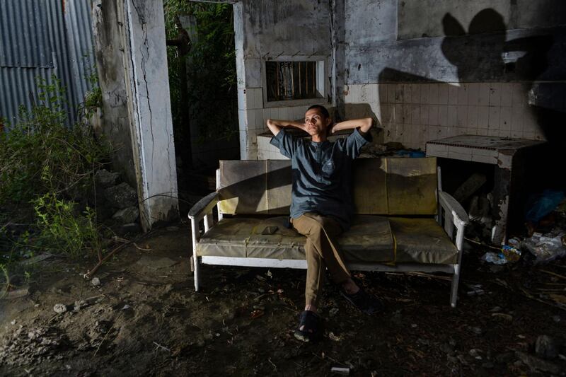 Ahadi Firsawan,a survivor of the December 26, 2004 tsunami, sitting in his house in Kajhu, Aceh province.  AFP