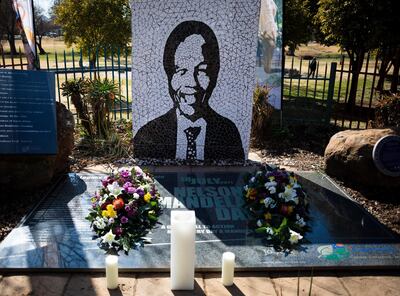 epa08551900 Flowers are laid at a memorial for the late Nelson Mandela in Soweto, Johannesburg, South Africa, 17 July 2020. Nelson Mandela Day is celebrated on 18 July every year.  EPA/KIM LUDBROOK