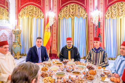 Moroccan King Mohammed VI, centre, with Spain's Prime Minister Pedro Sanchez, second left, Crown Prince Moulay Hassan, second right, Prince Moulay Rachid, the king's brother, right, and Morocco's Prime Minister Aziz Akhannouch, left, before an Iftar meal at the King Royal residence in Sale, Morocco, in April 7. Royal Palace/AP