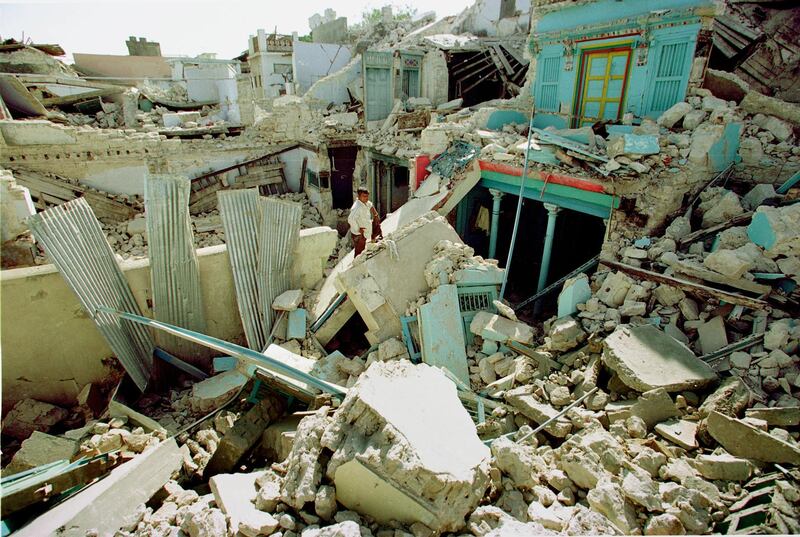 384915 05: A man stands in front of his home stunned by the destruction January 29, 2001 in the devastated village of Anjar, 40 k from Bhuj. Tens of thousands have died in this disaster so far, and an accurate count may never be known. (Photo Paula Bronstein/Liaison)