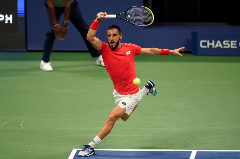 Damir Dzumhur, of Bosnia and Herzegovina, returns to Novak Djokovic, of Serbia, during the first round of the US Open tennis championships, in New York. AP