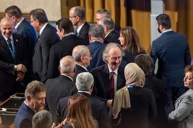 UN Special Envoy for Syria Geir Pedersen, centre, chats with a woman delegate as the Syrian Constitutional Committee met in Geneva on October 30, 2019. via AP